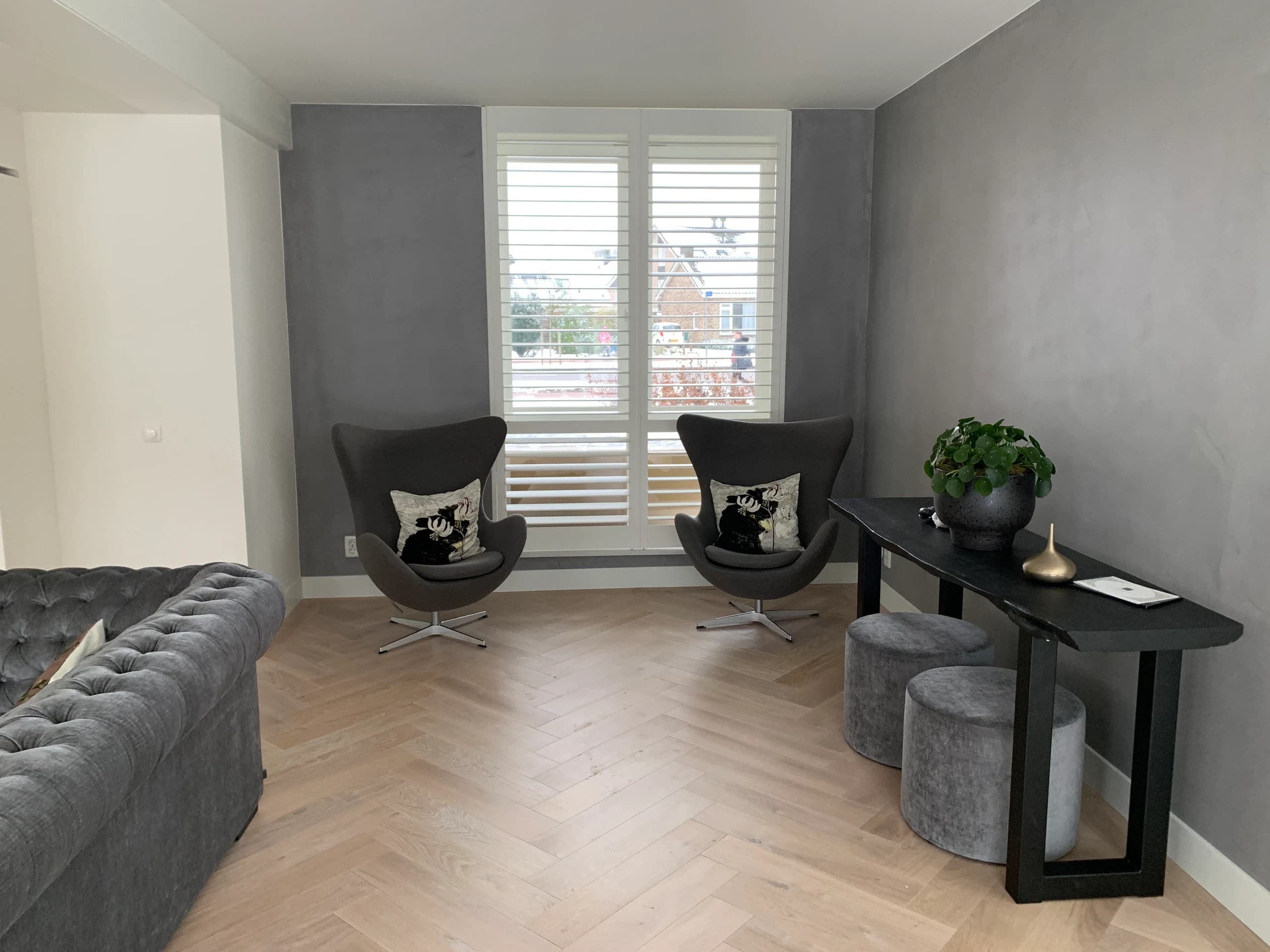 Zithoek met egg chairs en shutters op visgraat lamelparket, Vianen